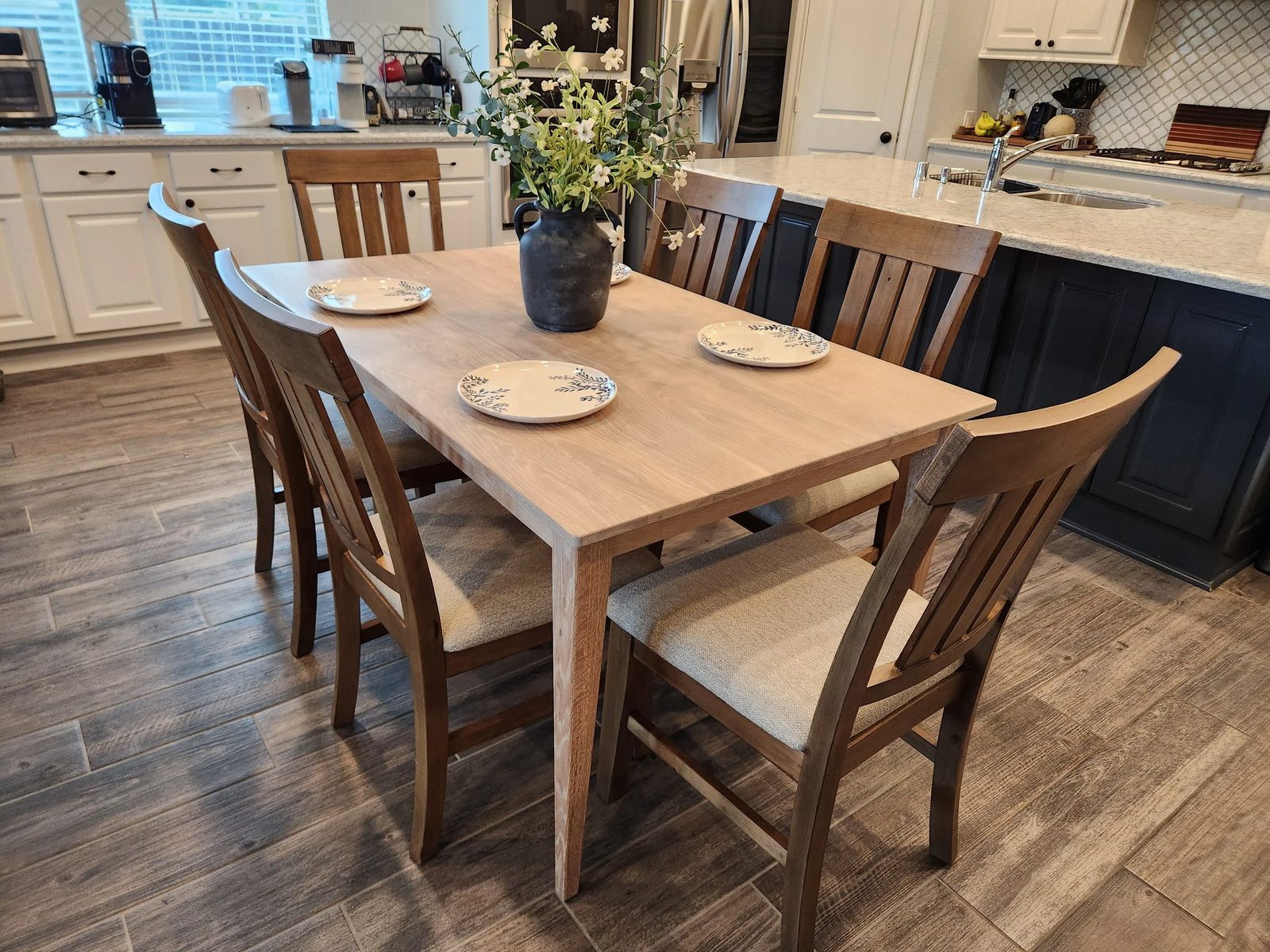 White oak dining table with six chairs in a family kitchen